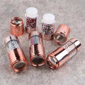 Detail of dual-ended nail art stamper set with rose gold finish and colorful rhinestones