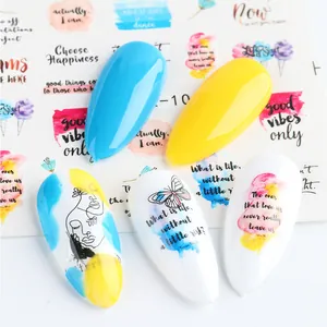 Detail of almond nail tips with blue, yellow colors and artistic water slide decals