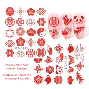 Detail of red Chinese style nail stickers featuring panda and lucky cloud motifs
