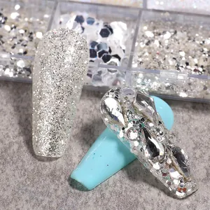 Detailed close-up of silver laser nail sequins and sparkling rhinestones on manicure
