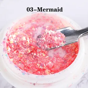 Macro shot of Mermaid 03 pink iridescent opal glitter flakes and stainless steel tool