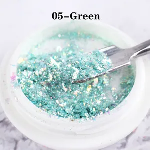 Macro detail of mint green iridescent opal nail powder in jar with metal scoop tool