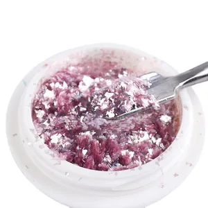 Iridescent purple opal nail glitter flakes in white jar for shimmering manicure designs