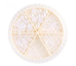 Detail of white half-round flatback pearls in six sizes inside a round clear storage box