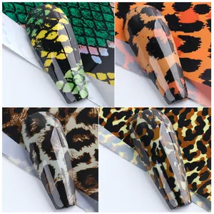 Detailed view of four animal print nail stickers featuring snake and leopard patterns