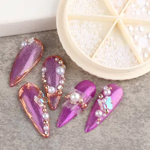 Detail of purple cat-eye false nails with mixed size white pearls and gold metal beads