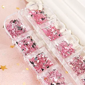Detail view of 12-grid organizer with heart and star shaped pink resin nail art rhinestones