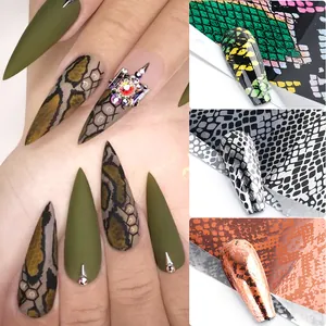 Detailed macro view of animal print nail foil with snake patterns and metallic accents