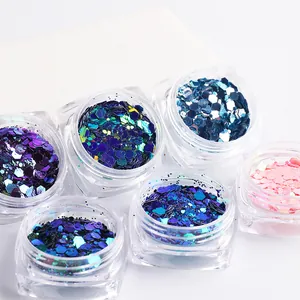 Macro shot of iridescent hexagonal nail sequins in various metallic chameleon colors