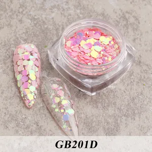 Macro shot of pink iridescent hexagon nail sequins in a jar and applied on manicure