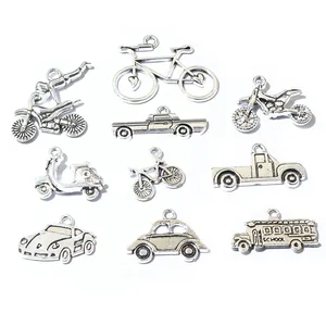 Macro detail of antique silver alloy charms featuring miniature vintage vehicle designs