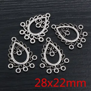 Macro view of teardrop alloy pendants with vintage hollow patterns, size 28x22mm