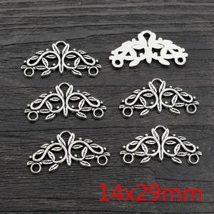 Macro detail of 14x29mm vintage silver leaf scroll alloy pendants and connectors