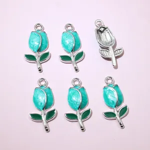 Macro shot of tulip charms with blue marble enamel and silver edges for jewelry making