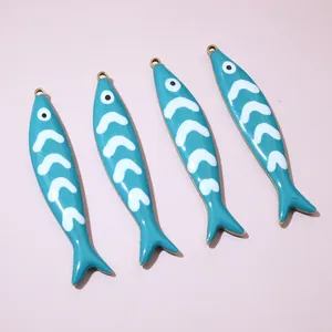 Detailed close-up view of four blue enamel fish pendants for DIY jewelry making crafts