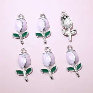 Detailed view of pink tulip flower charms with green leaves for DIY jewelry making