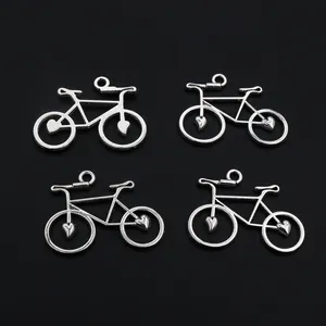 Set of four antique silver bicycle pendants with heart wheels for DIY jewelry making