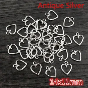 Detailed close-up of antique silver hollow heart charms for DIY jewelry 14x11mm