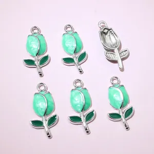 Detailed macro view of 6 pieces green tulip flower enamel charms for DIY jewelry making