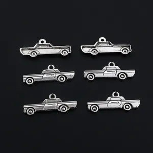 Detailed view of six vintage silver alloy car pendants for DIY jewelry making