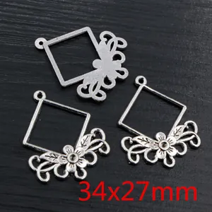 Macro shot of vintage silver alloy floral pendant connectors showing 34x27mm dimensions