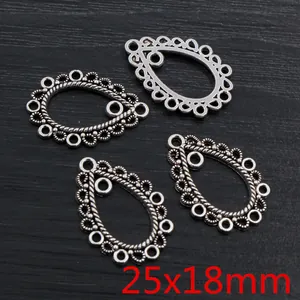 Macro view of four antique silver teardrop alloy pendants with bohemian lace patterns