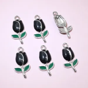 Detail of tulip pendants with black enamel flower and green leaf for DIY jewelry making