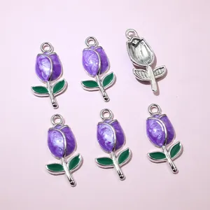 Detail of purple tulip charms with green leaves and silver metal frame for DIY jewelry