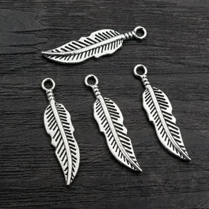 Set of 4 vintage alloy feather pendants in antique silver for DIY jewelry making