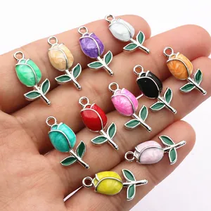 Colorful tulip flower alloy charms for DIY jewelry making shown in hand for scale