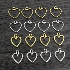 Golden and silver alloy hollow heart pendants for DIY jewelry making on wood background