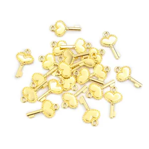Detailed macro view of heart-shaped key charms in polished gold finish for DIY jewelry