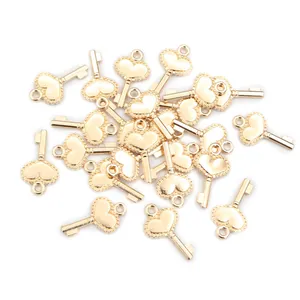 Macro shot of multiple vintage gold heart key charms for DIY jewelry making