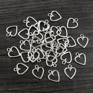 Hollow heart-shaped alloy pendant charms in bright silver for DIY jewelry making
