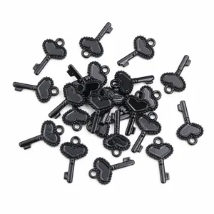 Macro detail of black heart-shaped key charms with beaded texture for DIY jewelry