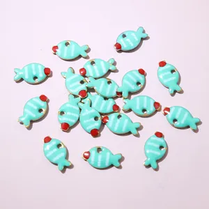 Detailed macro view of small blue fish pendants for DIY jewelry making accessories