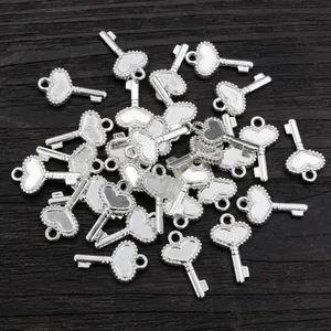 Macro shot of silver alloy heart-shaped key charms with frosted texture and dot border