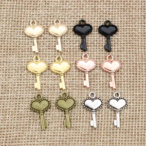 Set of 12 heart-shaped key charms in 6 metallic colors on burlap background for DIY jewelry