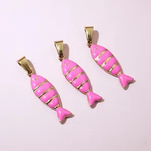 Detailed view of three pink enamel fish pendants with gold stripes and heart-shaped tails