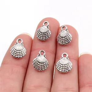 Set of five antique silver alloy scallop shell charms for DIY jewelry making and crafts