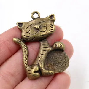 Close-up of vintage bronze lucky cat alloy pendant with detailed engravings and top hook