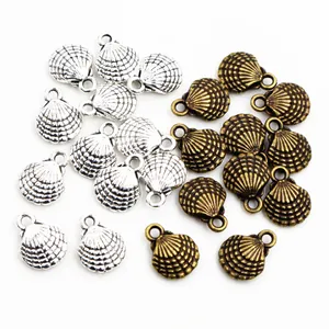 Macro view of silver and bronze alloy scallop charms for DIY jewelry making