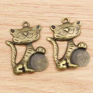 Macro detail of alloy fortune cat pendants with round bezel settings for DIY jewelry making