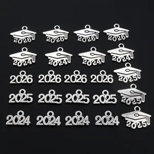 Detailed macro view of 2025 and 2026 graduation cap silver pendants for DIY jewelry