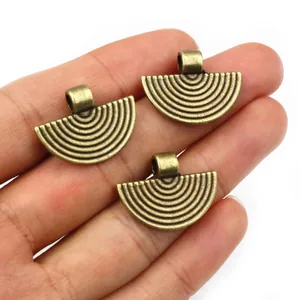 Three bronze fan-shaped alloy charms with textured relief for DIY jewelry making