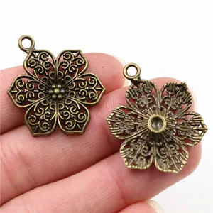 Antique bronze flower pendant for DIY jewelry, 32x24mm hollow floral charms in palm