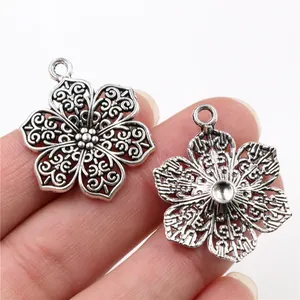 Vintage silver alloy flower pendant with hollow spiral pattern for DIY jewelry making