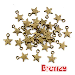 Macro shot of bronze star-shaped pendants for DIY jewelry making with a small loop