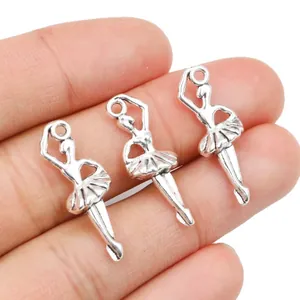 Set of three vintage silver alloy ballerina pendants shown held in hand for size reference
