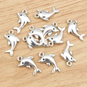 Silver dolphin alloy charms for DIY necklaces on a light wood grain background